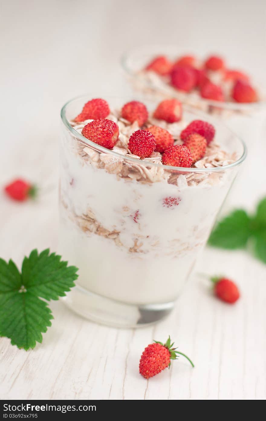 Natural yogurt with muesli and wild strawberries. Natural yogurt with muesli and wild strawberries