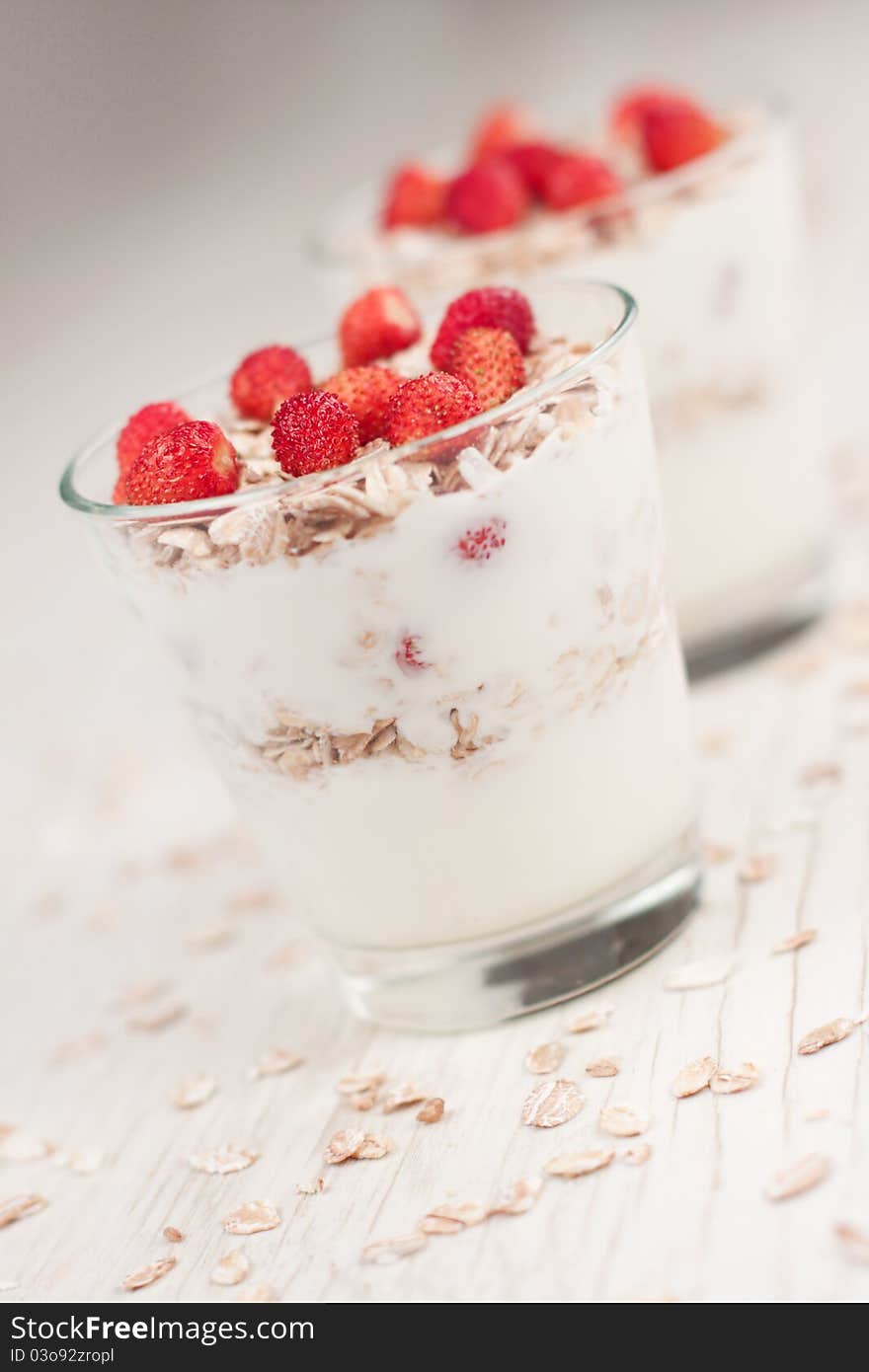 Natural yogurt with muesli and wild strawberries. Natural yogurt with muesli and wild strawberries