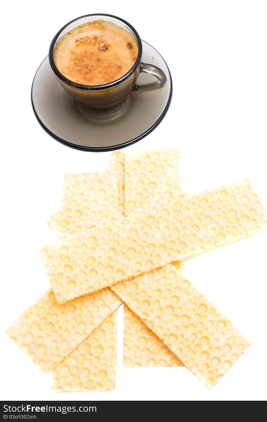 Cappuccino and wafer bread over white background