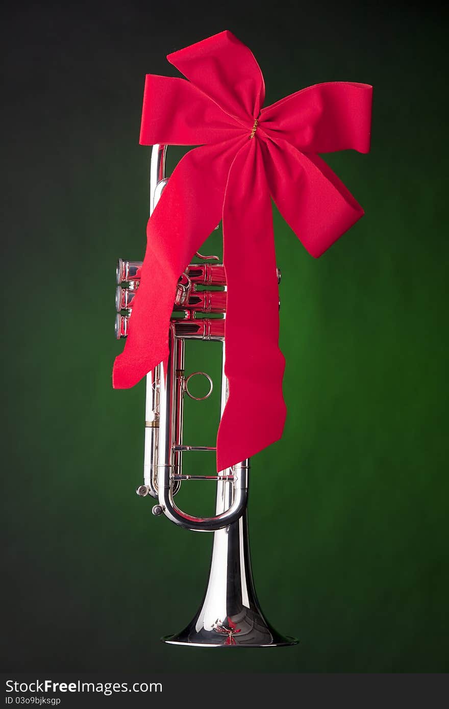 A professional silver and gold soprano saxophone isolated on a window shadow. A professional silver and gold soprano saxophone isolated on a window shadow.