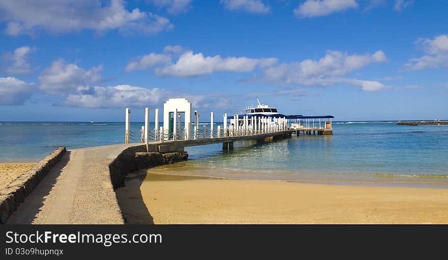 Boat docked on a beautiful pristine tropical island beach. Boat docked on a beautiful pristine tropical island beach.