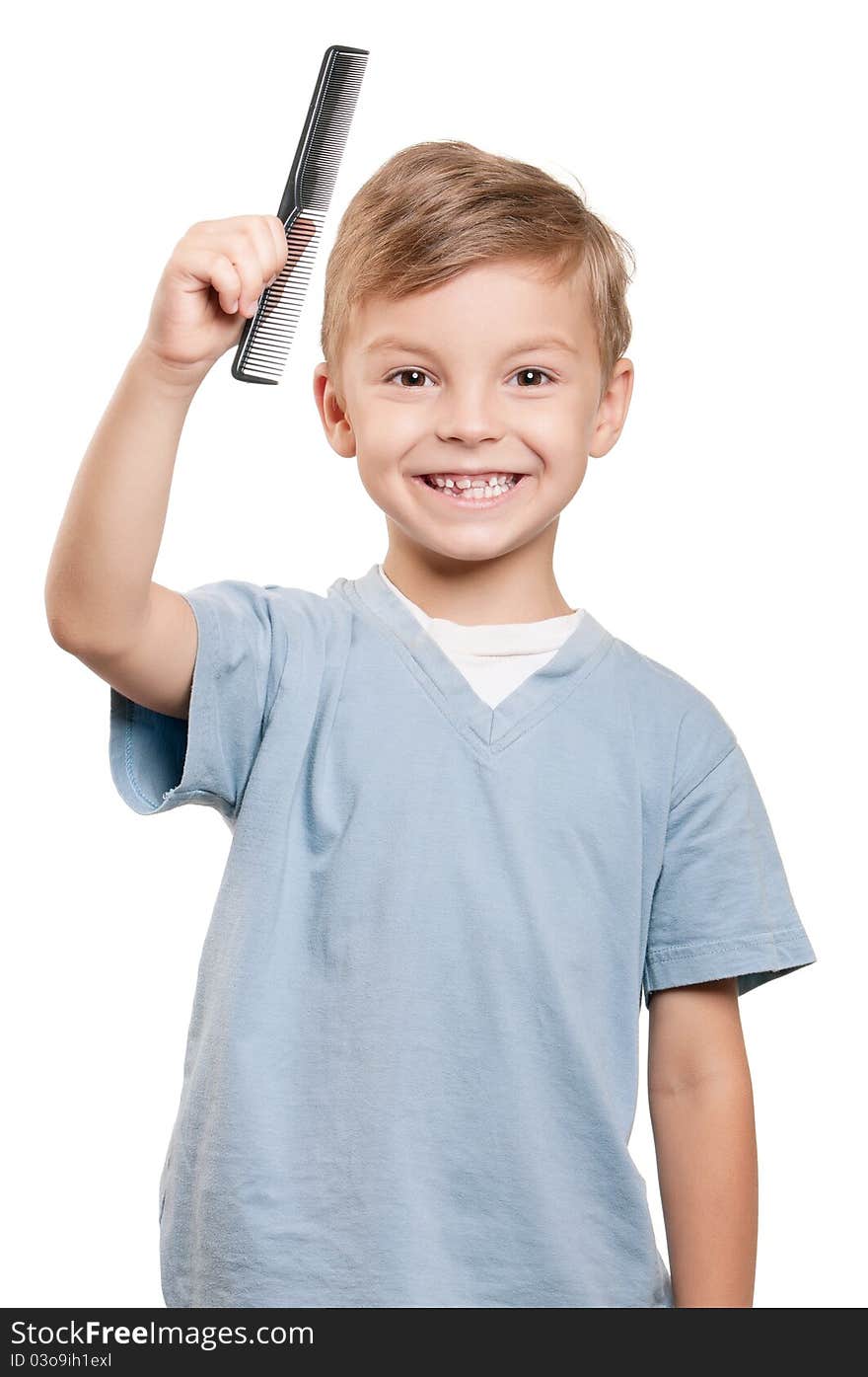 Portrait of a little boy holding a comb over white background. Portrait of a little boy holding a comb over white background