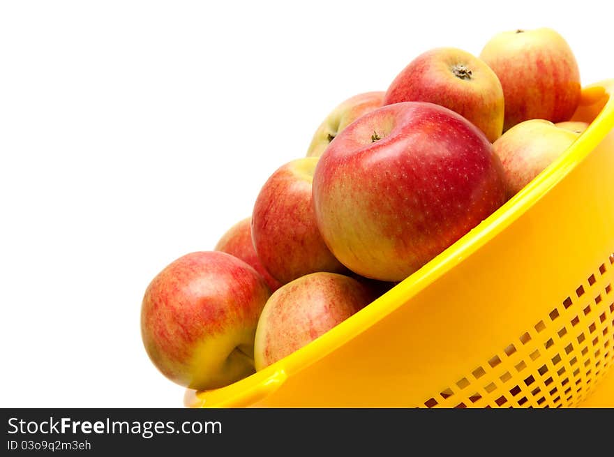 Apples in bowl on white background.