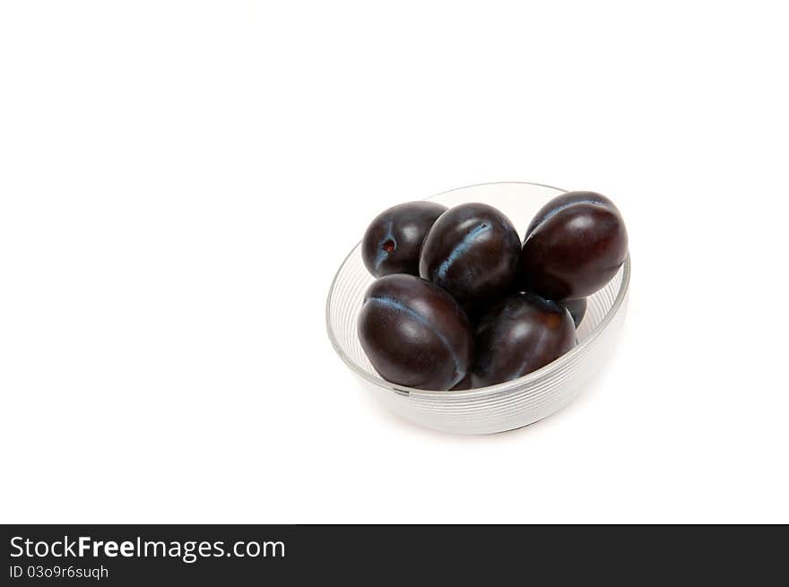 Close up of fresh three plum on white background