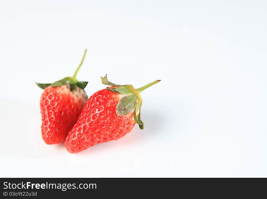 This is a fresh, bright red strawberry shot on a white background. It is cute shaped so it can work nicely with healthy eating concepts. This is a fresh, bright red strawberry shot on a white background. It is cute shaped so it can work nicely with healthy eating concepts.