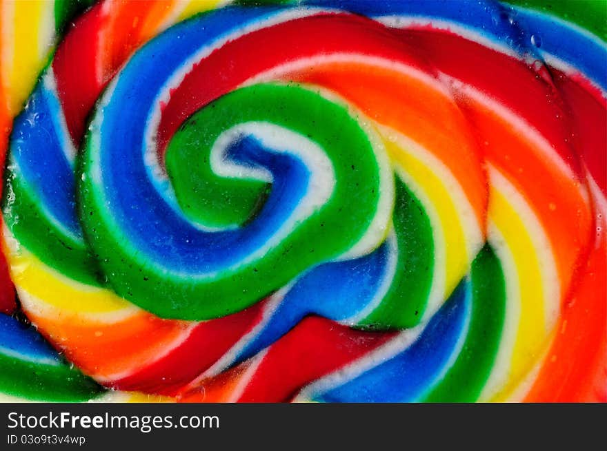 Abstract view of old fashioned swirled lollipop with water drops on it. Abstract view of old fashioned swirled lollipop with water drops on it