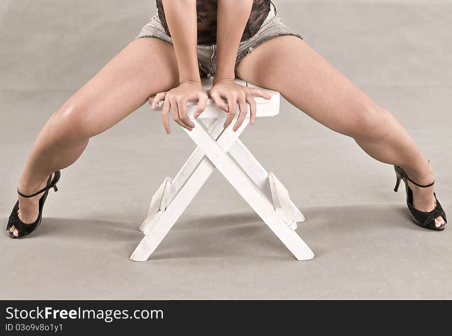 Legs of a woman while sitting down. Legs of a woman while sitting down