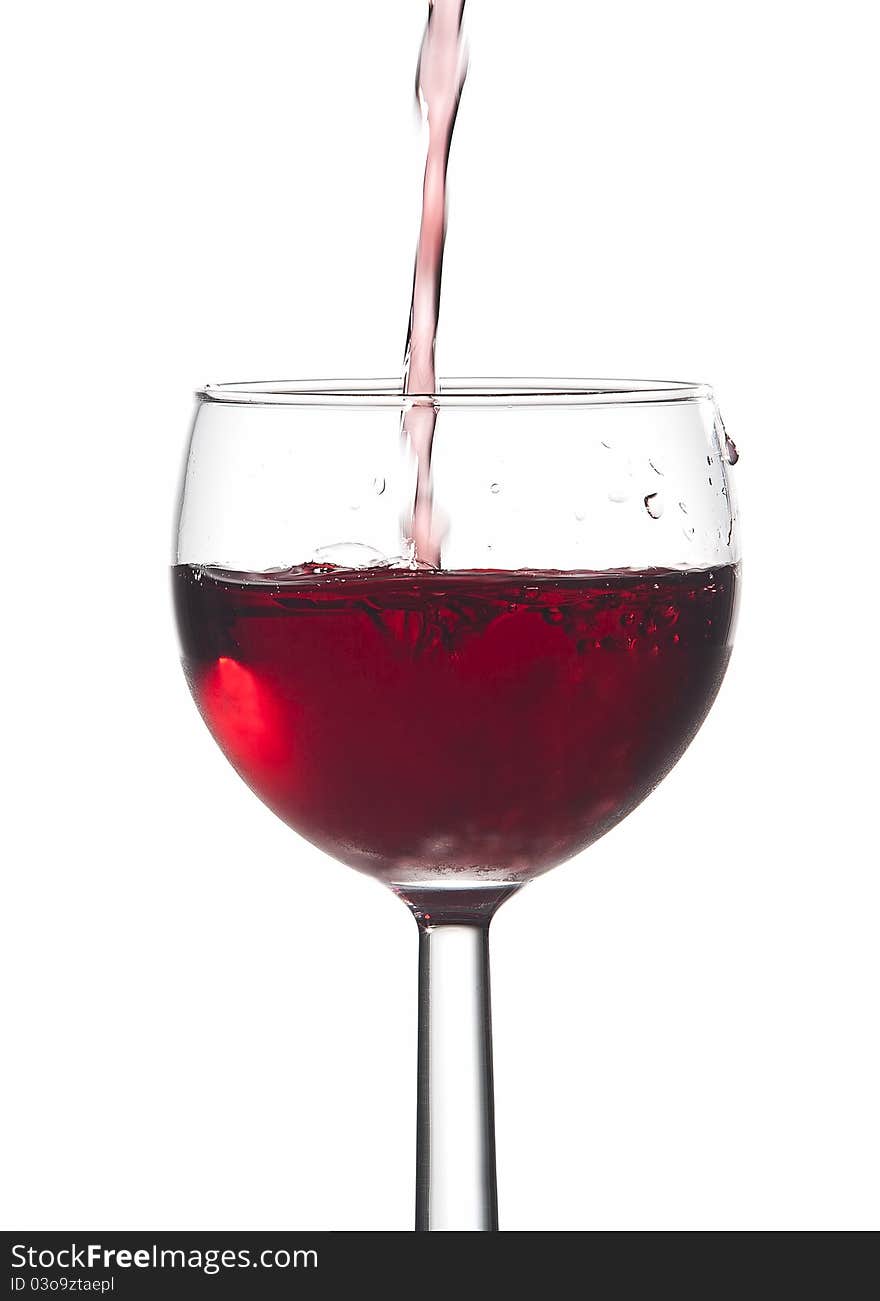 Bubbles from pouring red wine into a glass against a white background. Bubbles from pouring red wine into a glass against a white background.