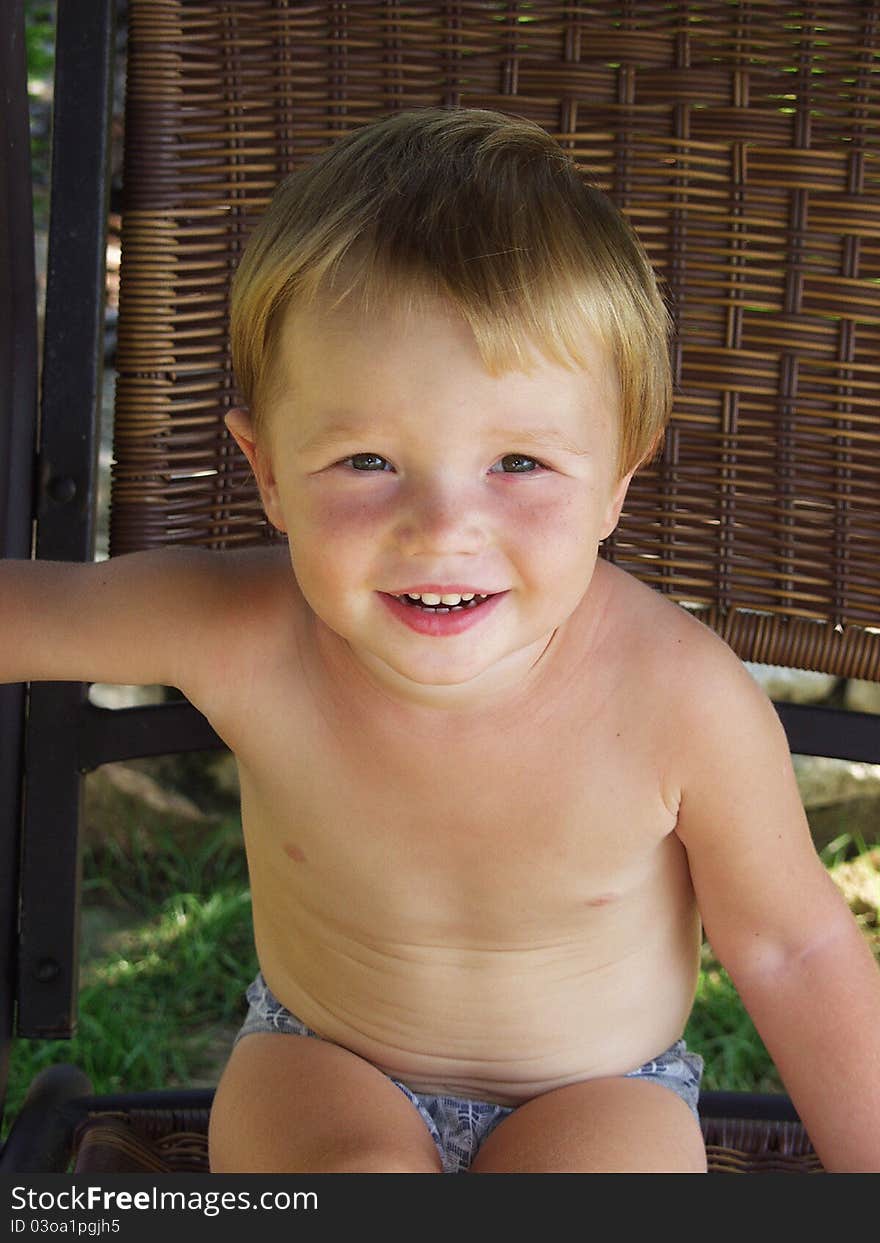 Smiling baby. Portrait of a boy in the garden