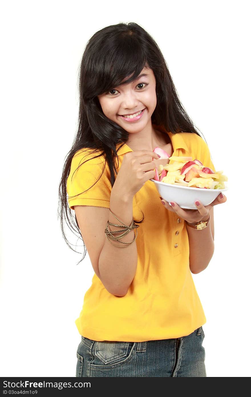 Young healthy girl having a fruit salad