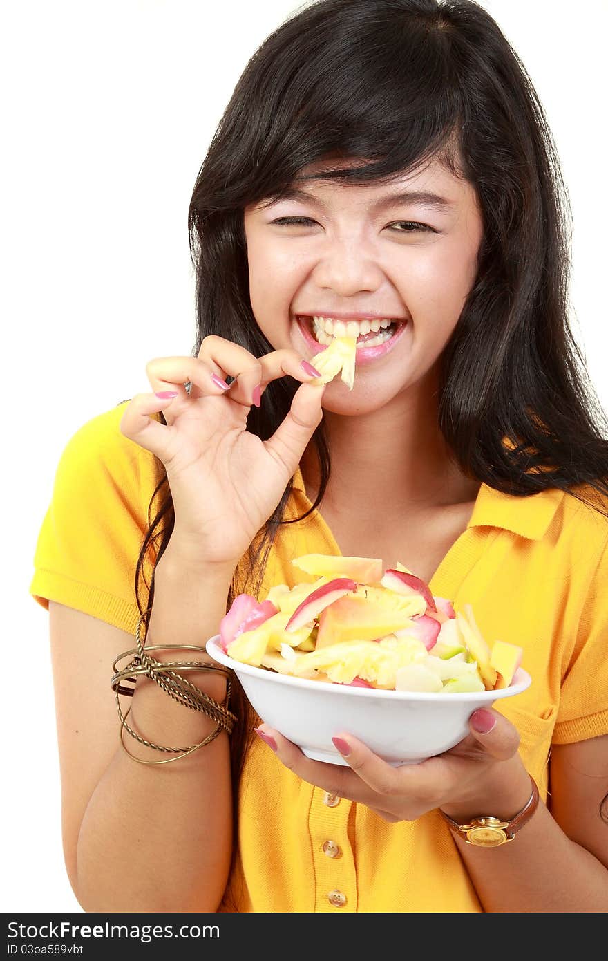 Beauty, young girl holding fruit salad isolated on white