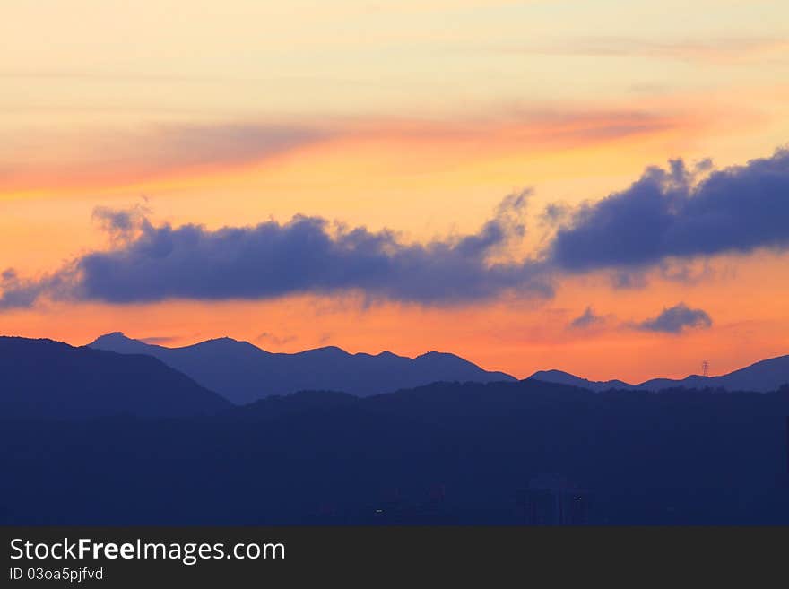 There are continuous mountains under sunset time. There are continuous mountains under sunset time.