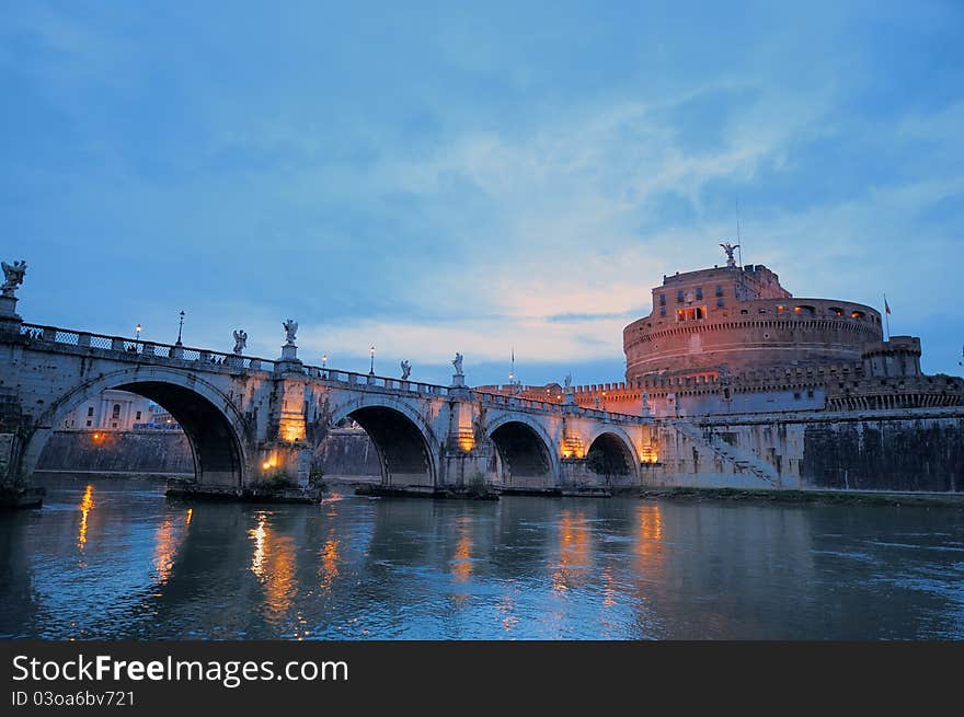 Bridge crossing the river Tiber and Castle in twilight