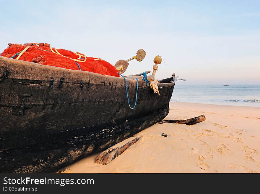 Old fishing boat on the sandy beach in Goa. Old fishing boat on the sandy beach in Goa