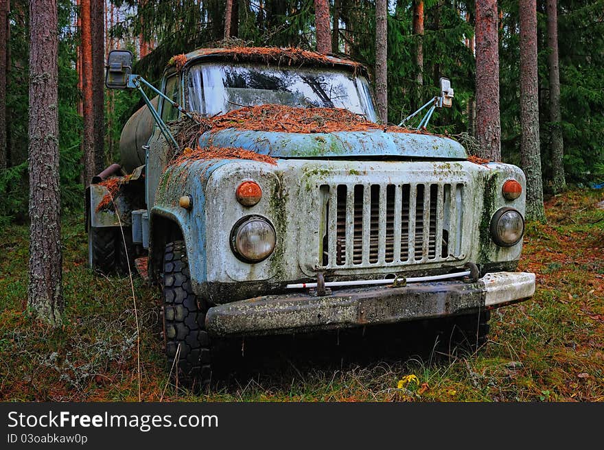 Old tank truck in the coniferous forest