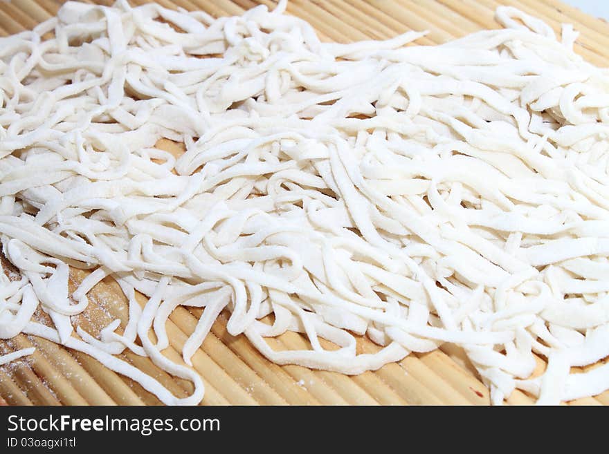 Cooking noodle with white paste and flour.