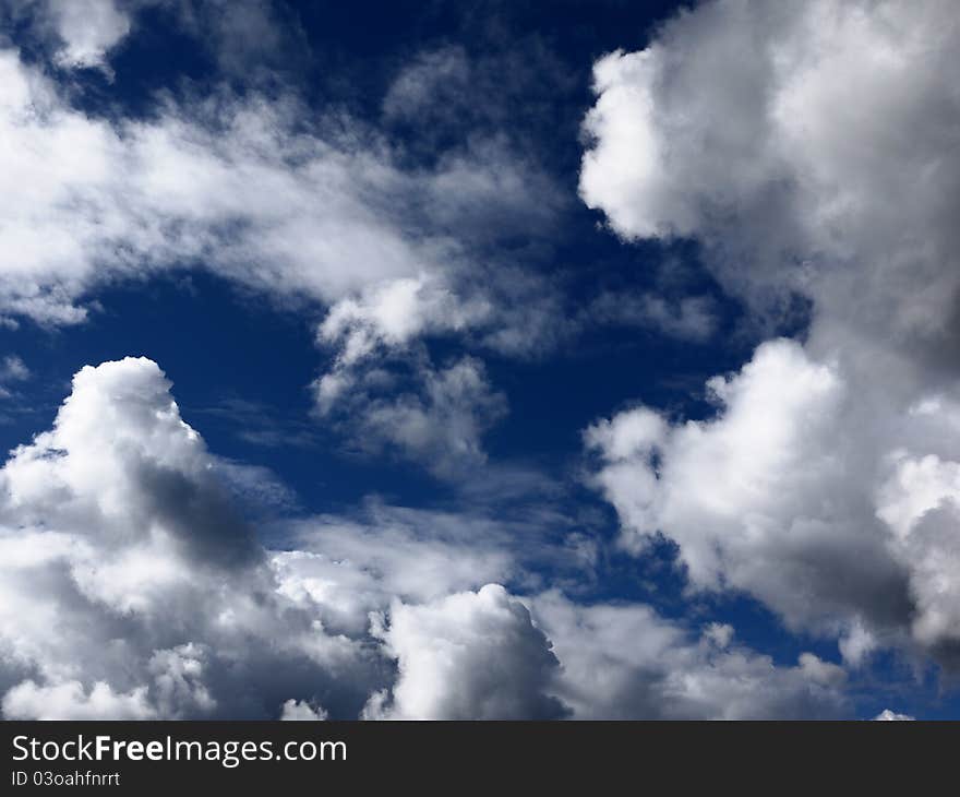 Brightly lit clouds against a blue sky. Brightly lit clouds against a blue sky