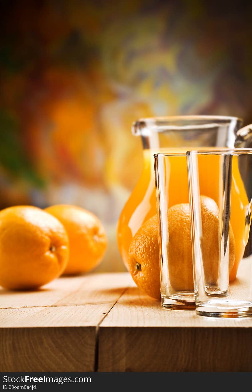 Composition of emty glass and orange juice with oranges on wooden boards. Composition of emty glass and orange juice with oranges on wooden boards