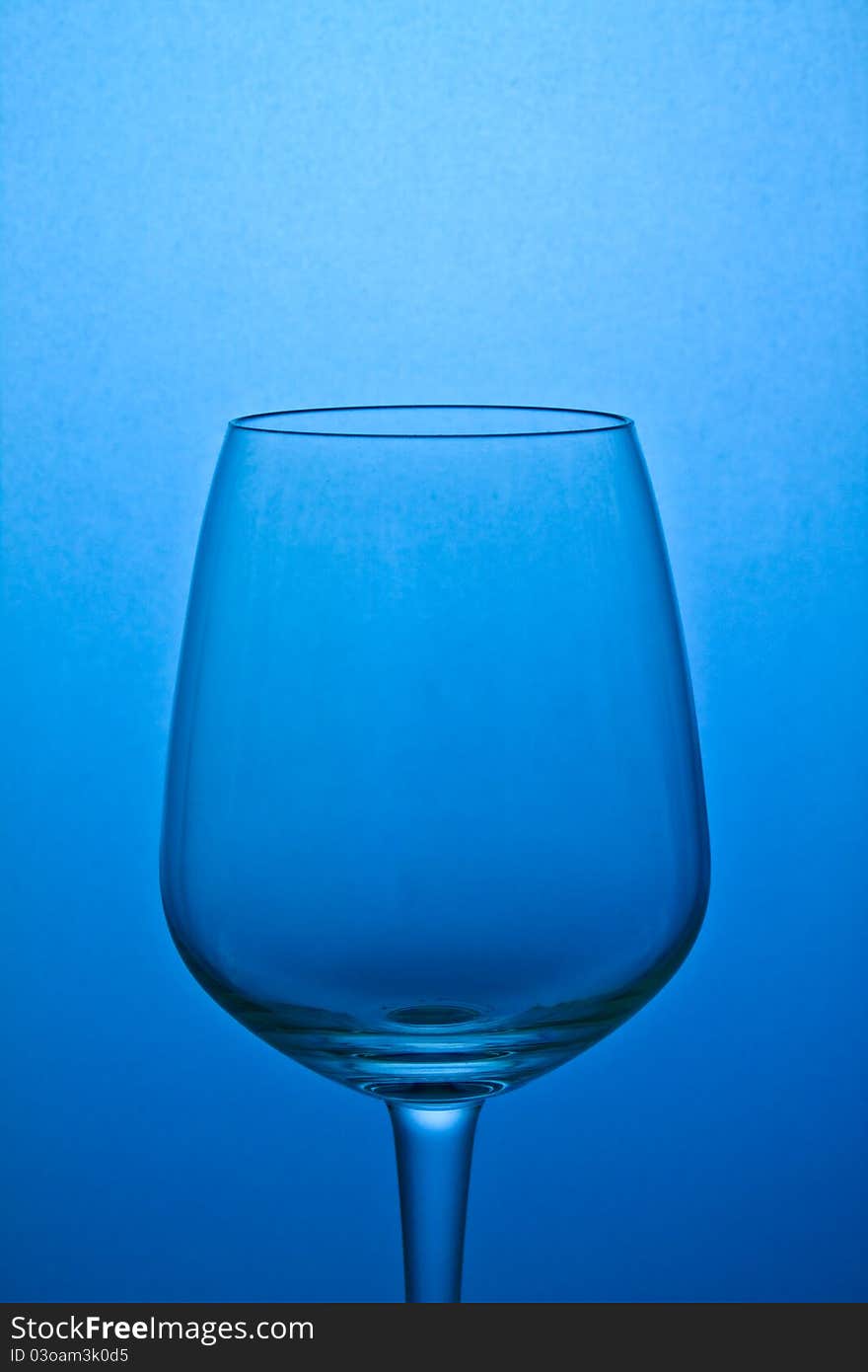 Empty wine glass isolated on blue background