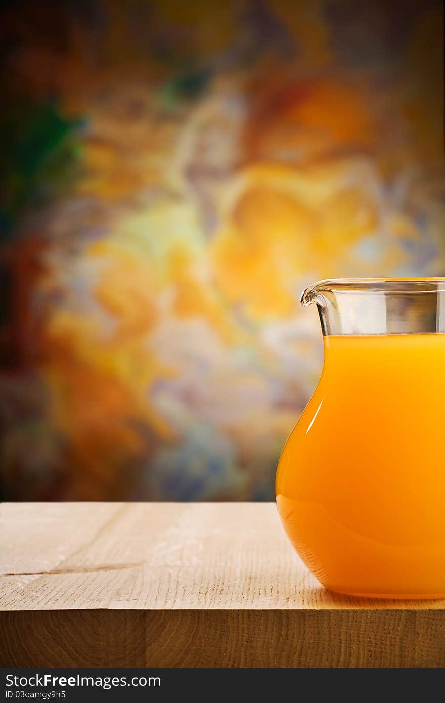 Studio shot copy space image composition of glass jug of the oranges juice on wooden boards