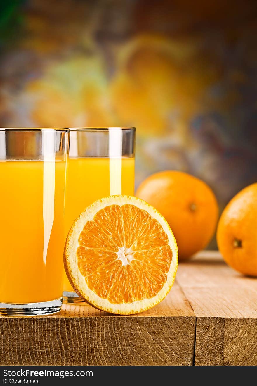 Oranges and juice of oranges in glass and jug On wooden boards.