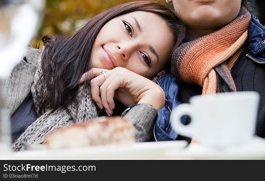 Close-up of happy female sitting at caffee leaning on her boyfriend shoulder. Close-up of happy female sitting at caffee leaning on her boyfriend shoulder