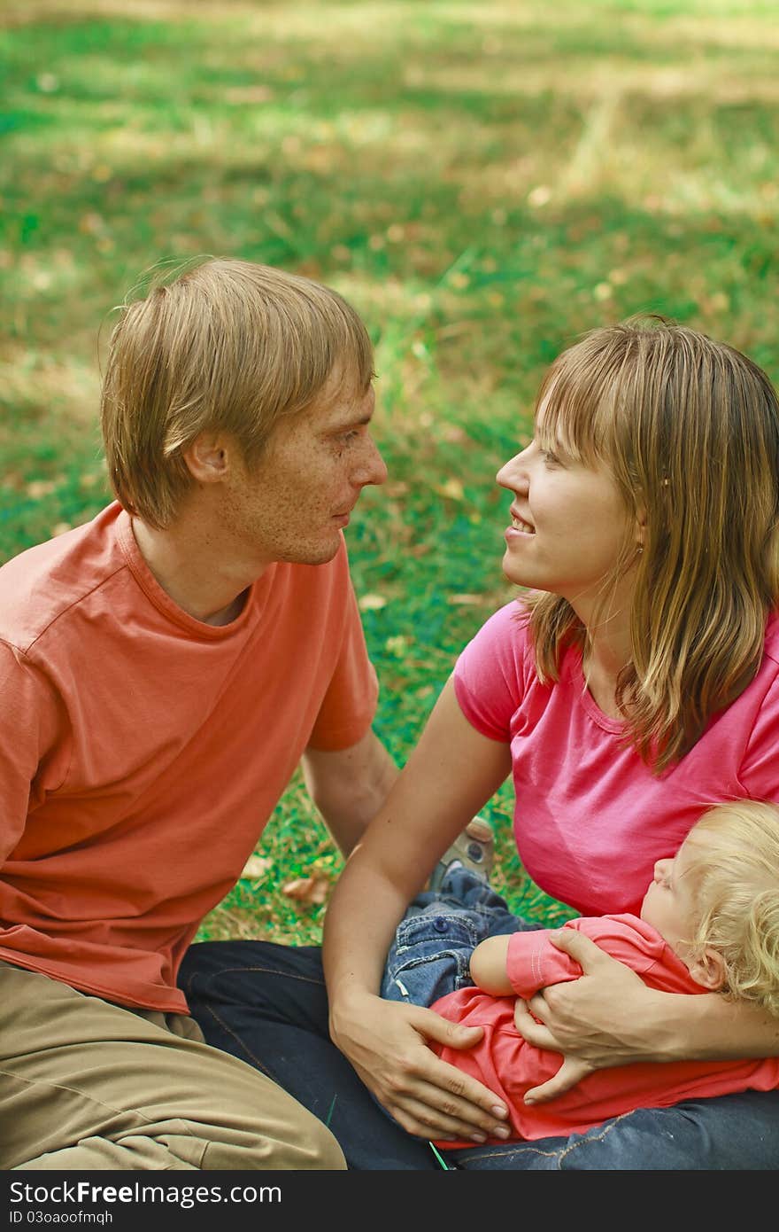 Young loving family in summer nature