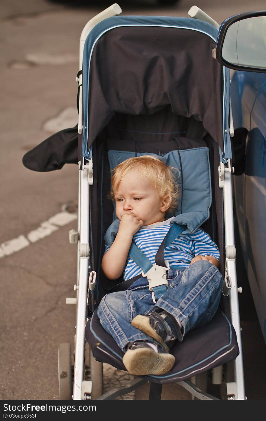 Baby waiting to travel with thoughful expression