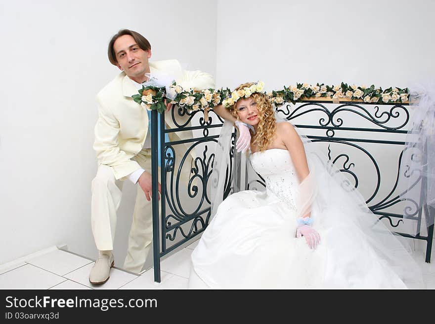 Young couple posing in a studio on the wedding day