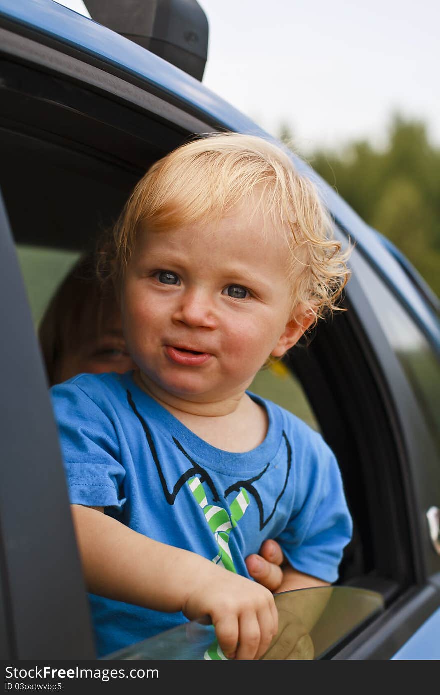 Happy baby looking from the car window