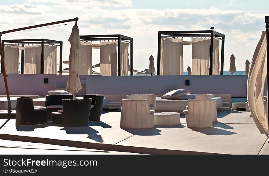 Luxury hotel resort patio with a wooden and a plastic furniture. . Luxury hotel resort patio with a wooden and a plastic furniture. .