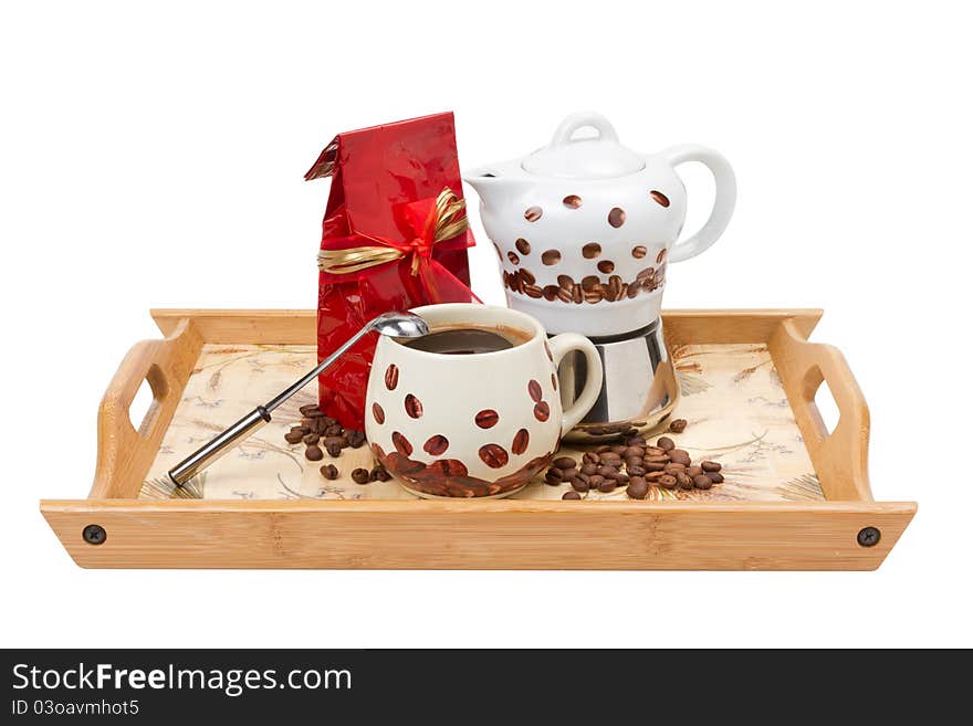 Coffee pot with cup, red bag on wooden tray, isolated