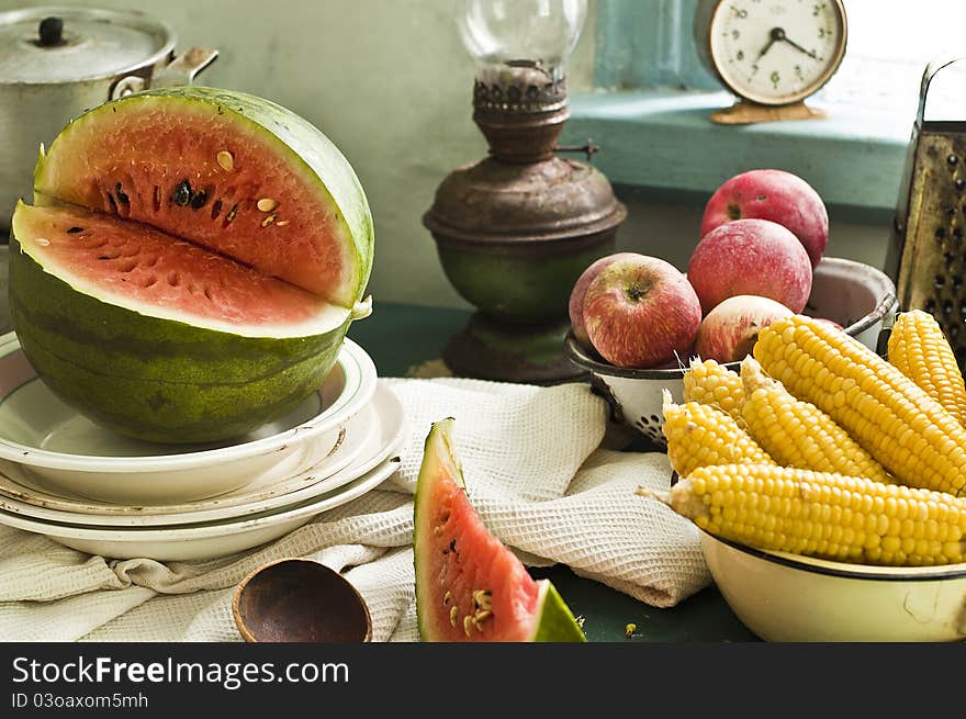 Fruit and vegetables with tableware on a table