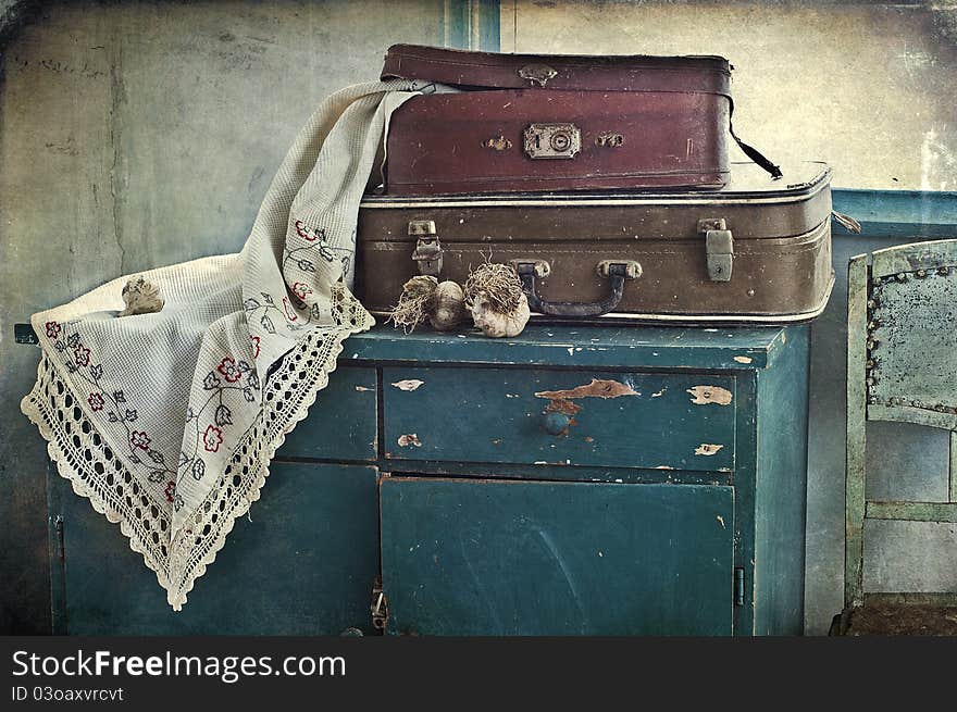 Old suitcases and garlic on a table