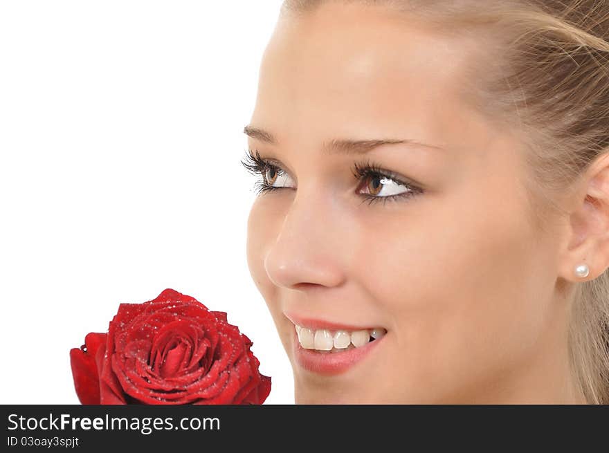 Young woman with rose full of water drops