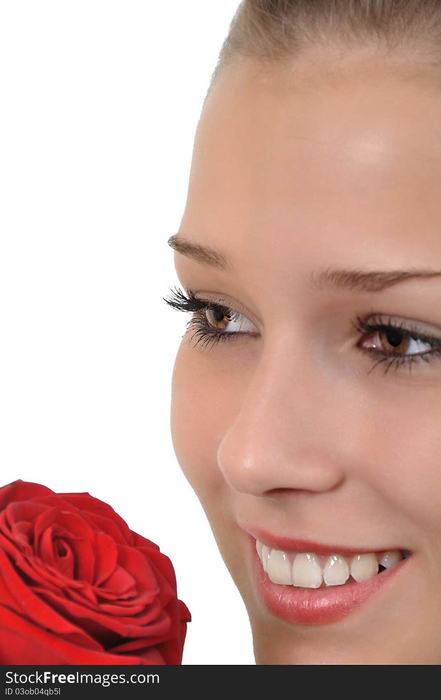 Young woman with red rose looks dreamy