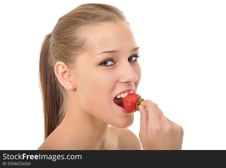 Woman with braids biting into a strawberry