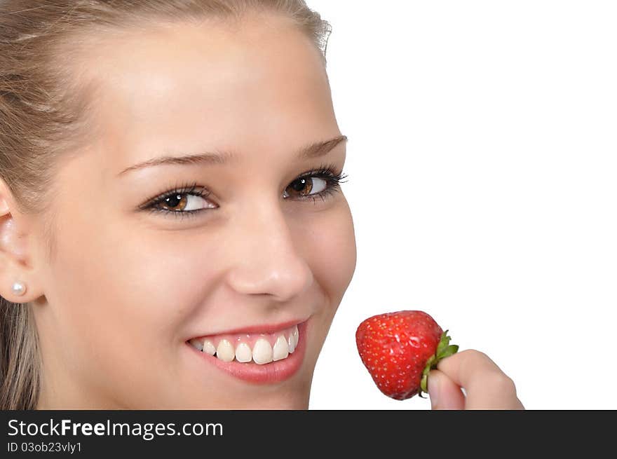 Young woman holding a red strawberry