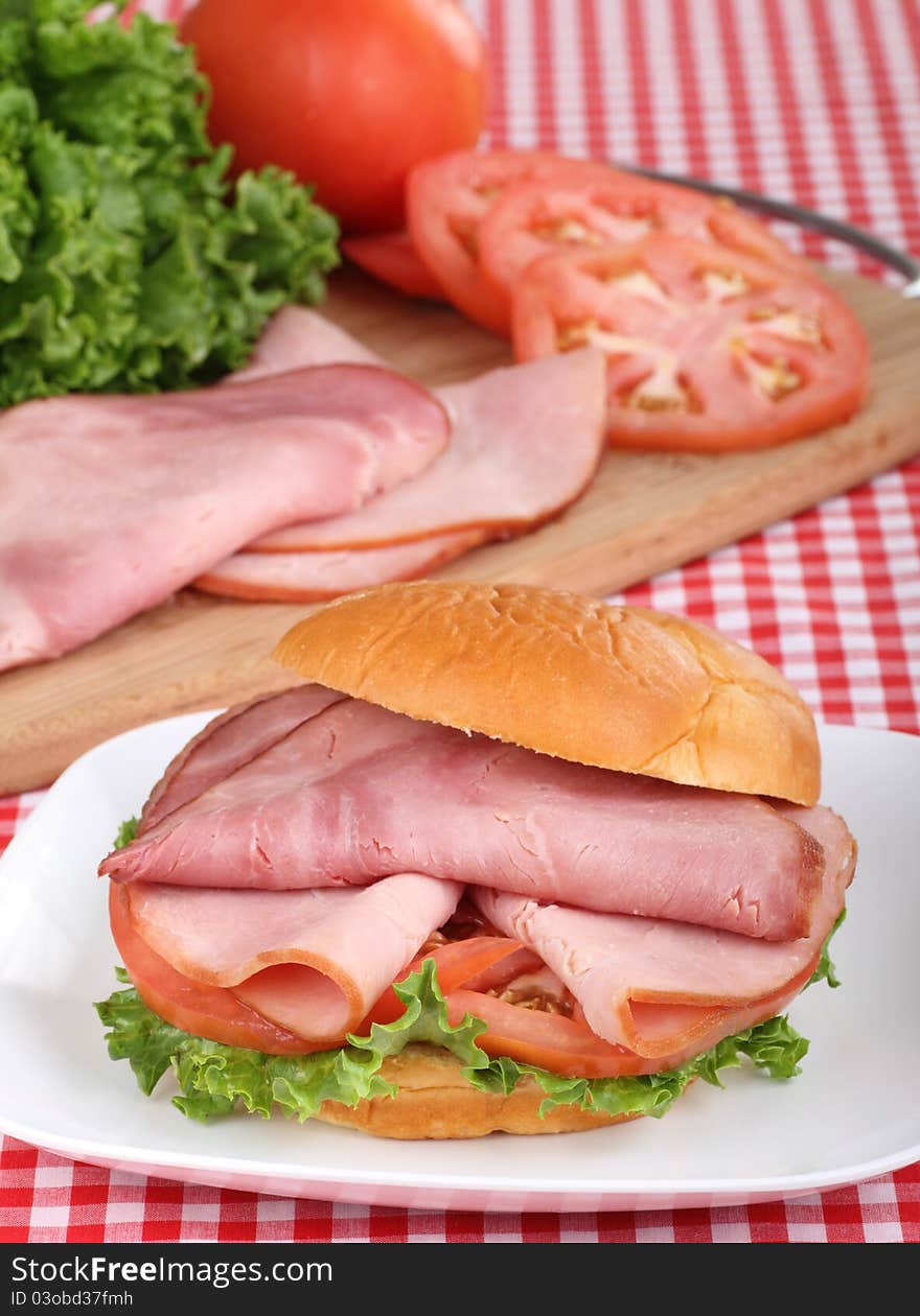 Ham sandwich with lettuce and tomato on a bun