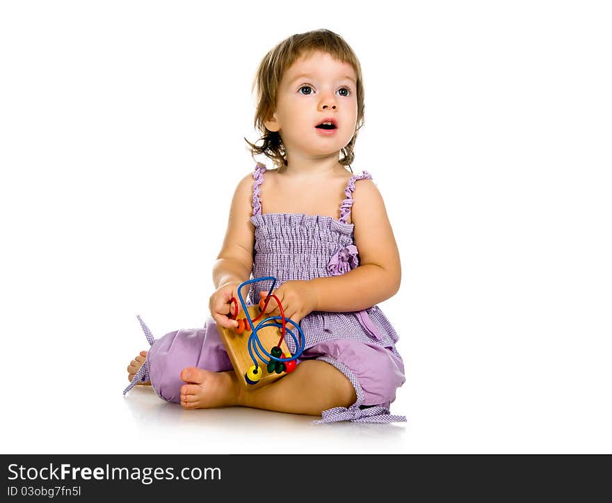 Small baby with developmental toy on a white background