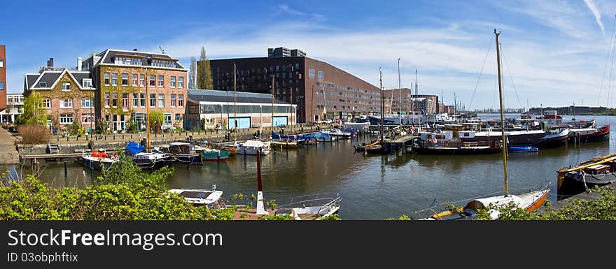 Channels in Amsterdam. Modern residential districts. Marina for boats and yachts.