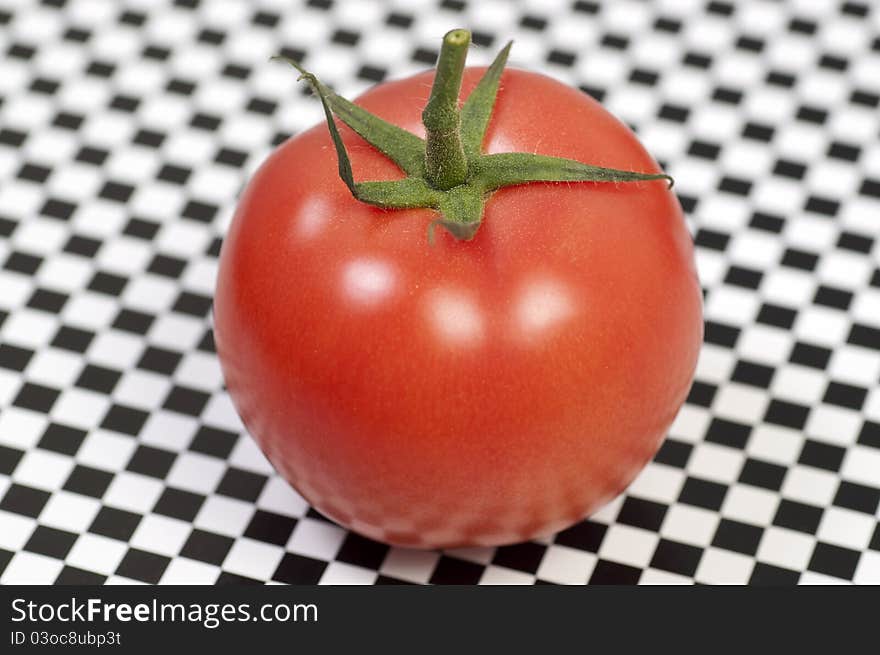 Isolated fresh tomato on pattern background