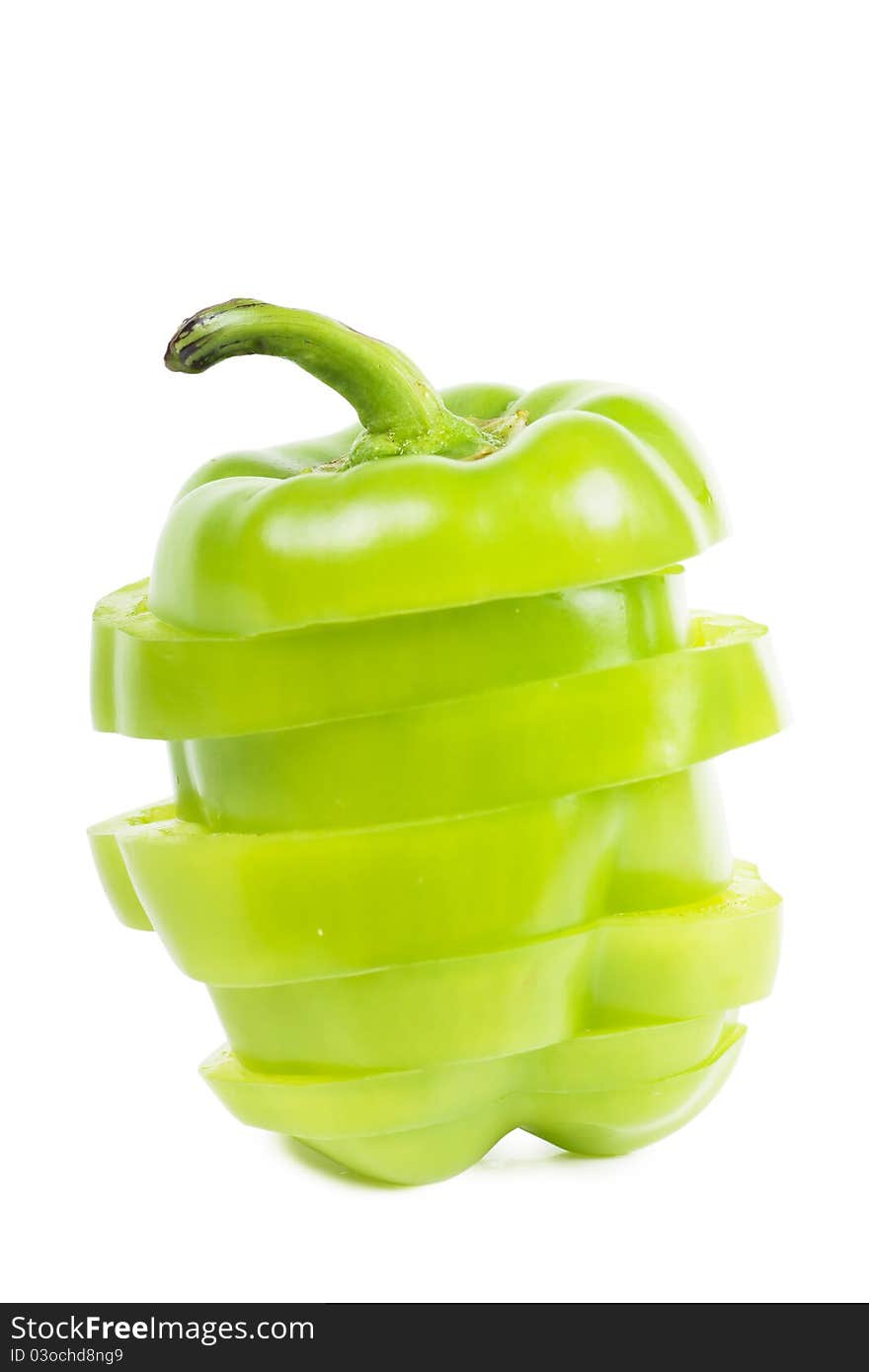 Cutted sweet green pepper over white background