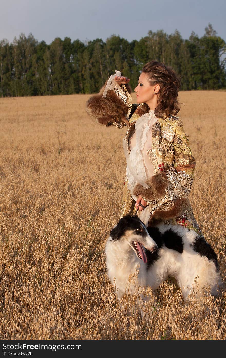 Woman in clothes of 18 centuries outdoors hold borzoi dog. Woman in clothes of 18 centuries outdoors hold borzoi dog