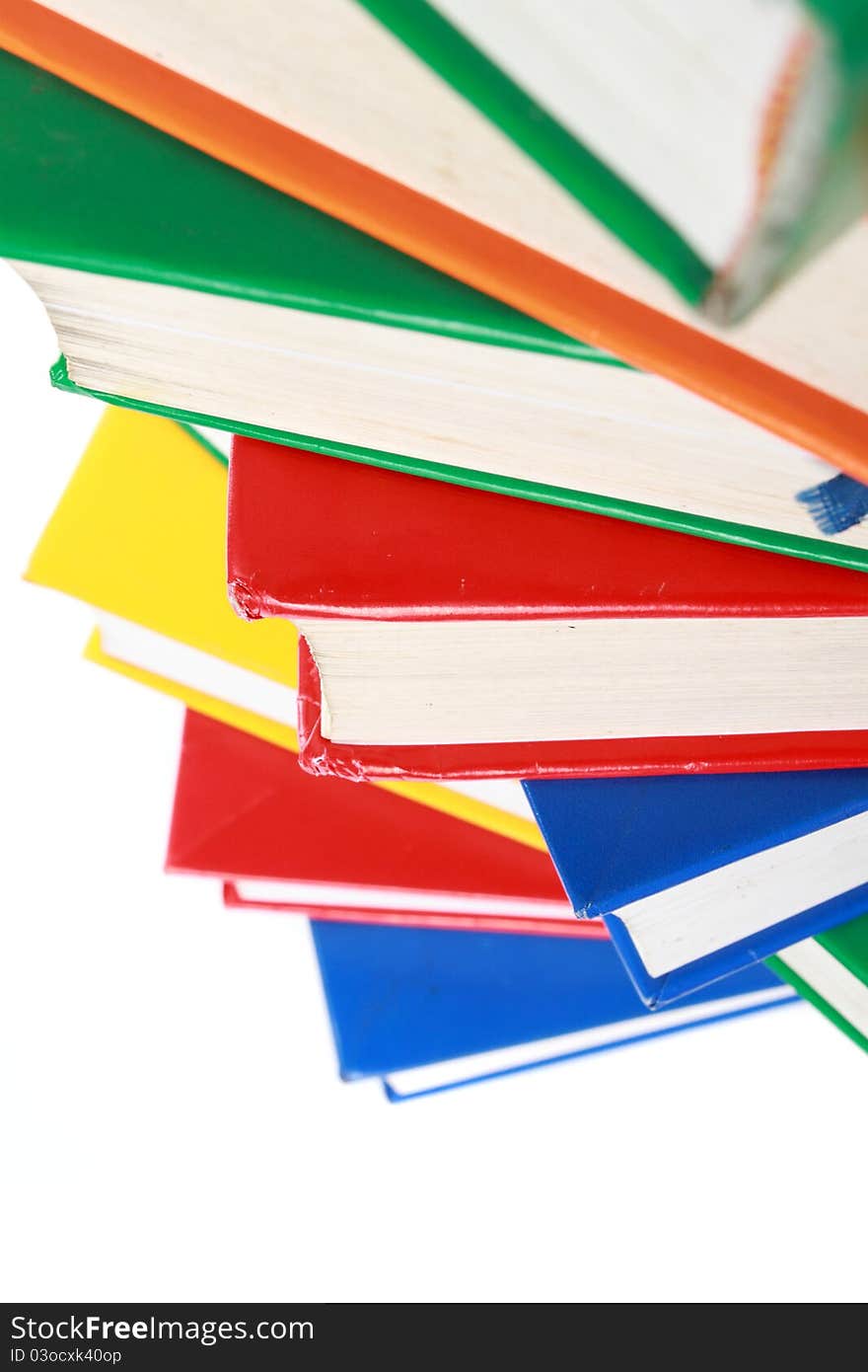 Pile of many colorful books isolated on white background