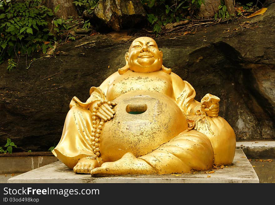 Happy buddha in front of the cave temples in Thailand.