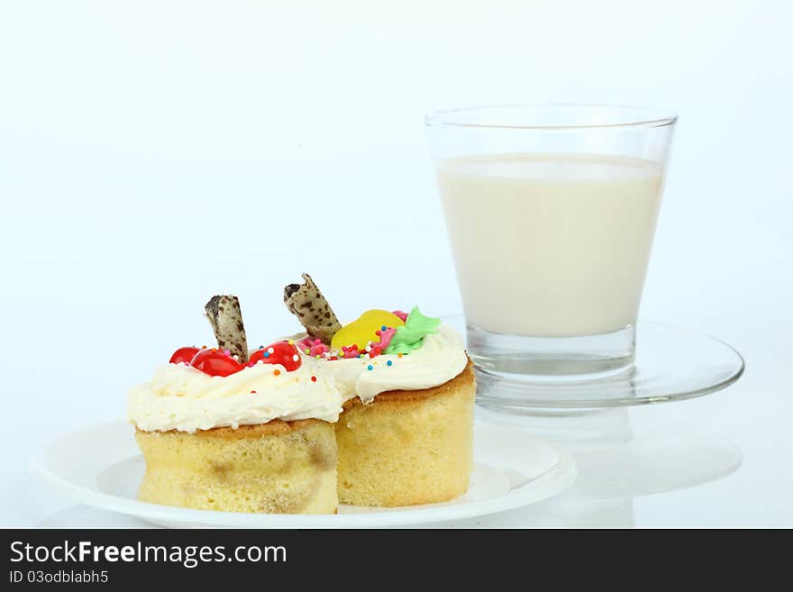 Cup cake and milk on white background