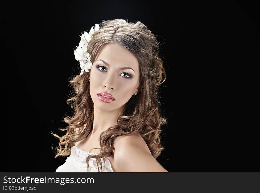 Portrait of beautiful bride with flowers in hair on black. Portrait of beautiful bride with flowers in hair on black