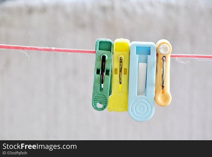 Clothespin hang on a cord on white