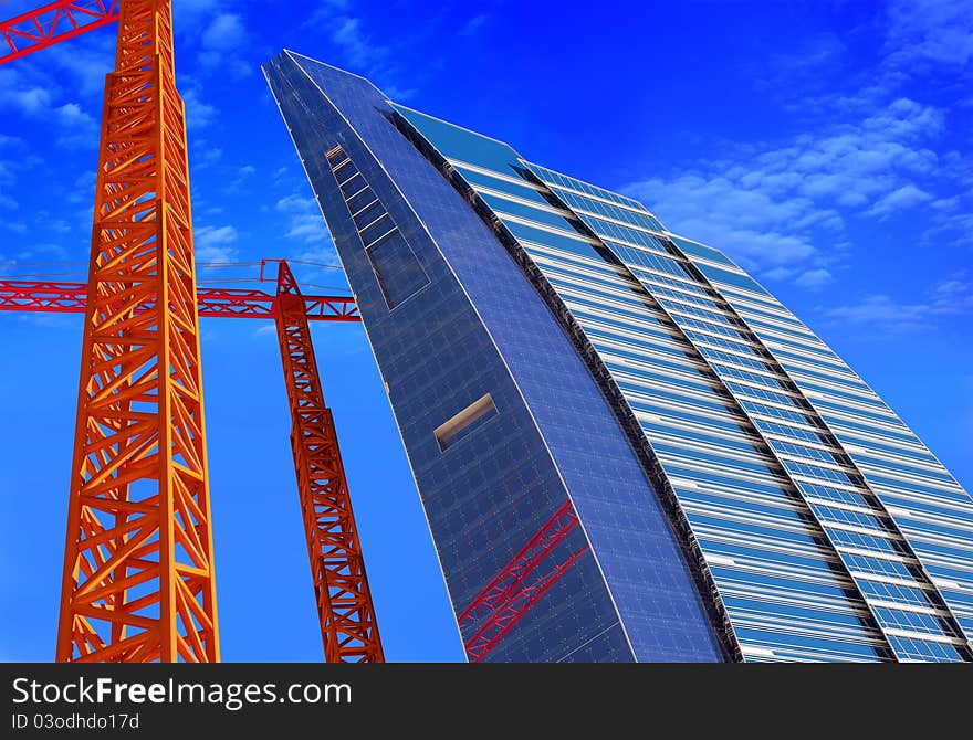 Skyscraper construction crane and a blue background.